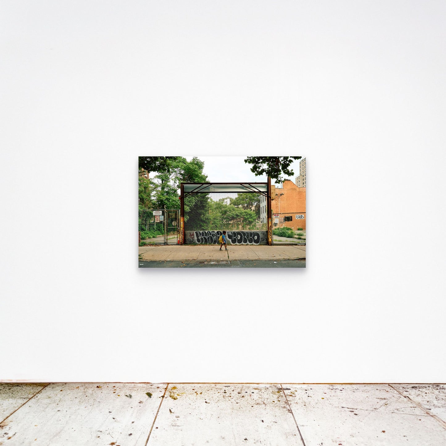 Chloe Albert's fine art print 'Boy Walking' shown unframed at 36 by 24 inches on a gallery wall, displaying the print at scale in a room setting.