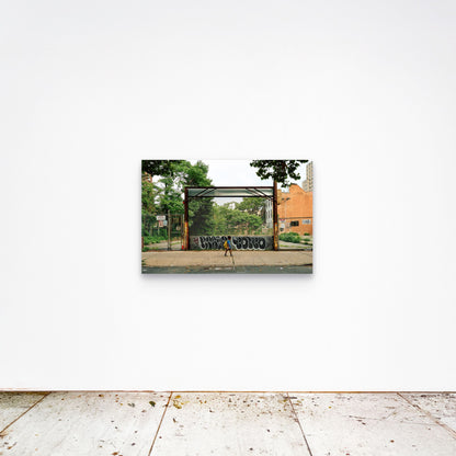 Chloe Albert's fine art print 'Boy Walking' shown unframed at 36 by 24 inches on a gallery wall, displaying the print at scale in a room setting.