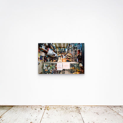 Chloe Albert's fine art print 'Cobbler' shown unframed at 36 by 24 inches on a gallery wall, displaying the print at scale in a room setting.