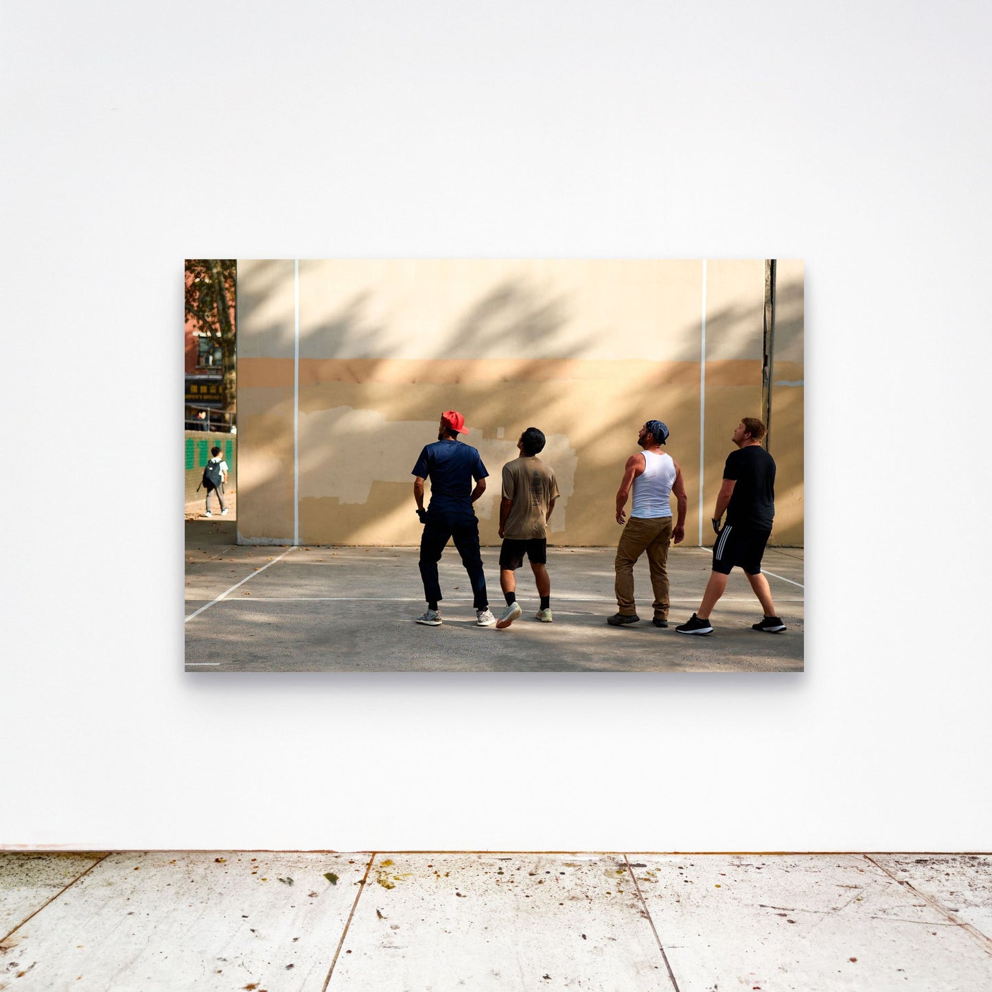 Chloe Albert's fine art print 'Collective Gaze' shown unframed at 60 by 40 inches on a gallery wall above a concrete floor, displaying the large statement size in a room.