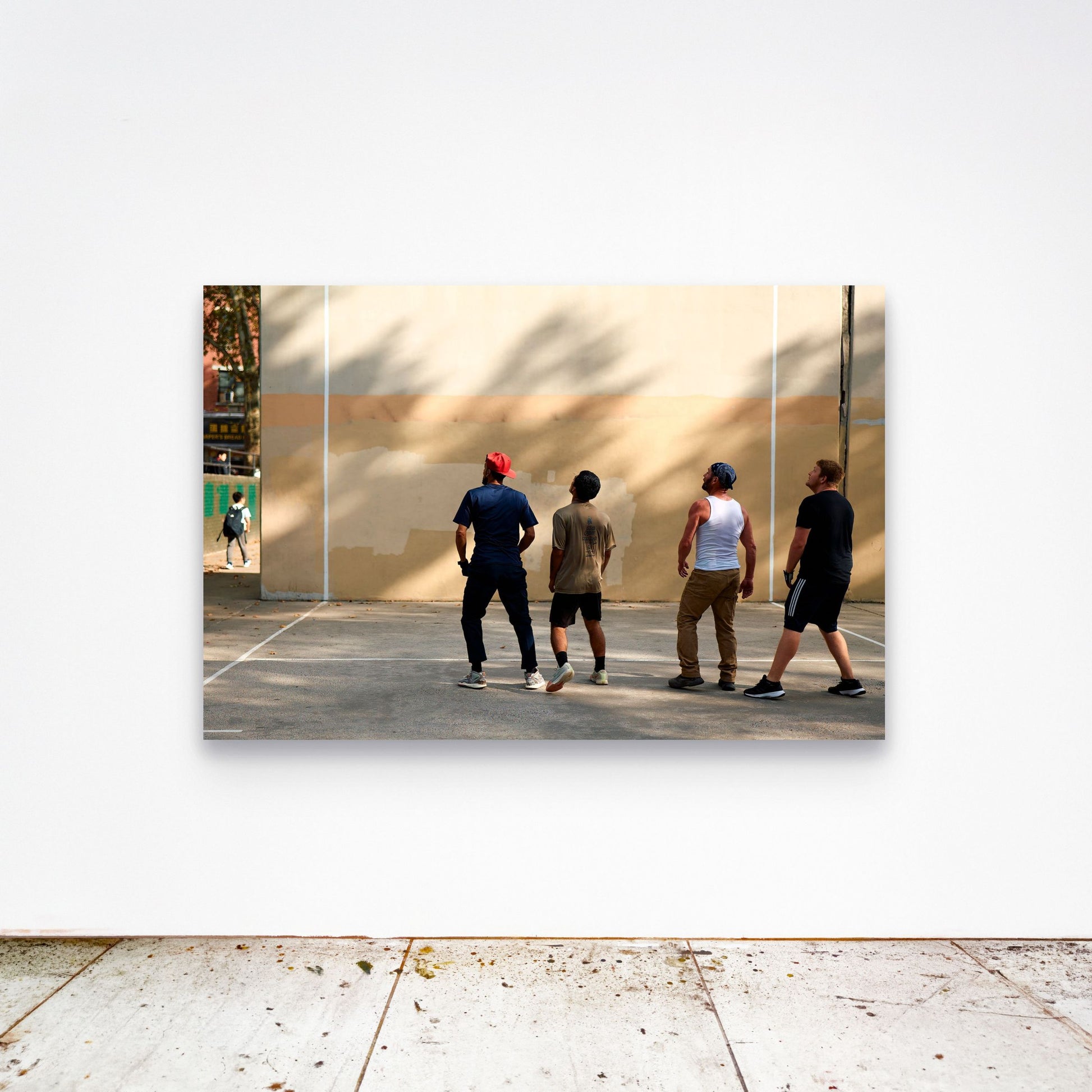 Chloe Albert's fine art print 'Collective Gaze' shown unframed at 60 by 40 inches on a gallery wall above a concrete floor, displaying the large statement size in a room.