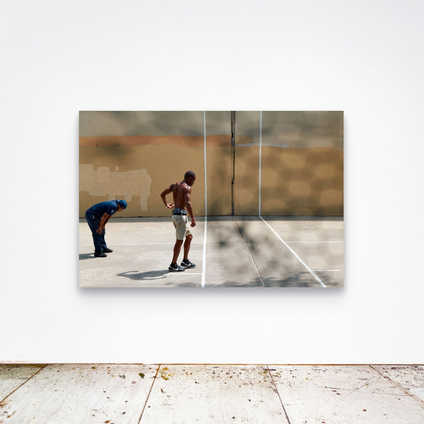 Chloe Albert's fine art print 'Concrete Womb' shown unframed at 60 by 40 inches on a gallery wall above a concrete floor, displaying the large statement size in a room.