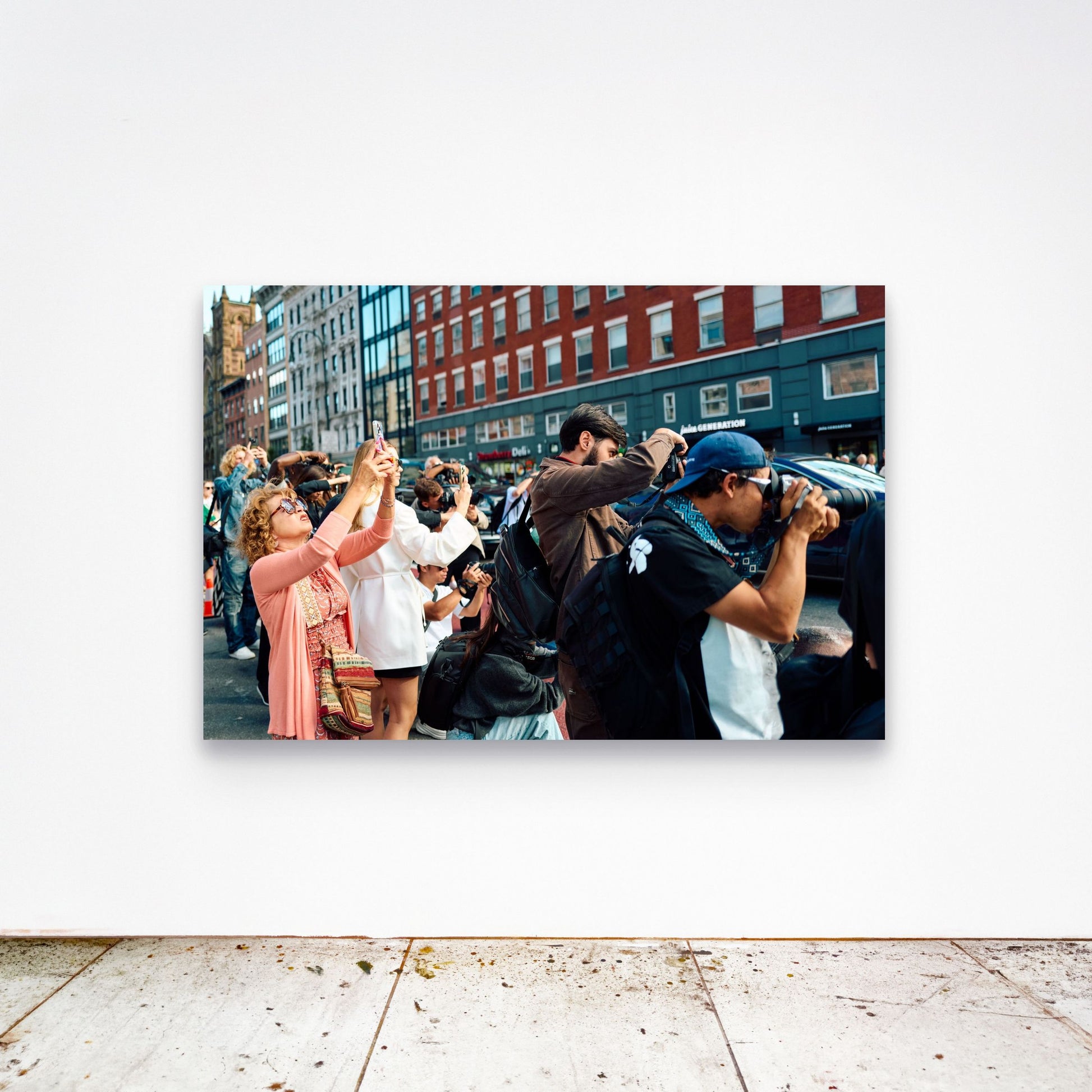 Chloe Albert's fine art print 'Crowd' shown unframed at 60 by 40 inches on a gallery wall above a concrete floor, displaying the large statement size in a room.