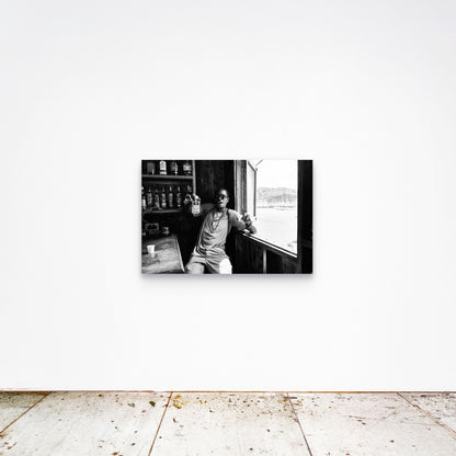 Chloe Albert's fine art print 'Dive Bar' shown unframed at 36 by 24 inches on a gallery wall, displaying the print at scale in a room setting.