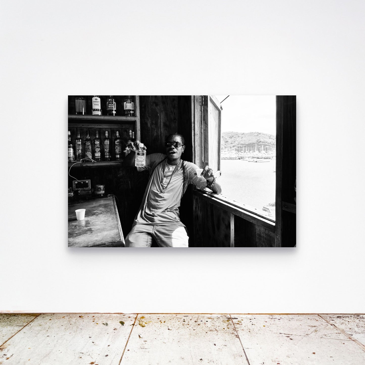 Chloe Albert's fine art print 'Dive Bar' shown unframed at 60 by 40 inches on a gallery wall above a concrete floor, displaying the large statement size in a room.