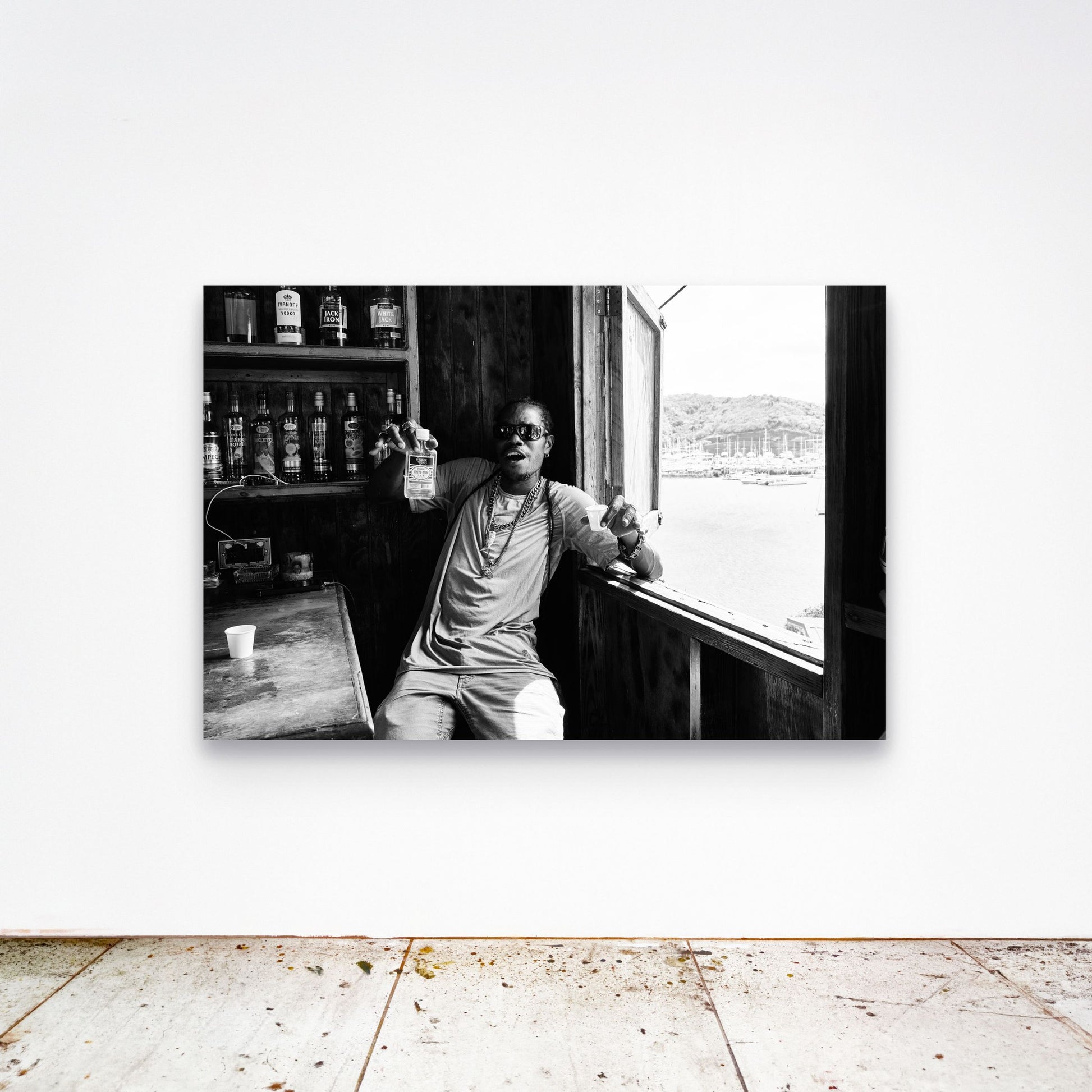 Chloe Albert's fine art print 'Dive Bar' shown unframed at 60 by 40 inches on a gallery wall above a concrete floor, displaying the large statement size in a room.