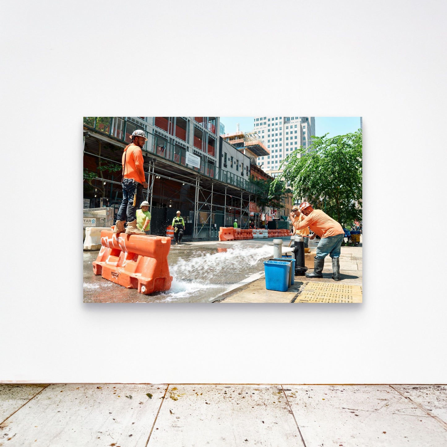 Chloe Albert's fine art print 'Fire Hydrant' shown unframed at 60 by 40 inches on a gallery wall above a concrete floor, displaying the large statement size in a room.