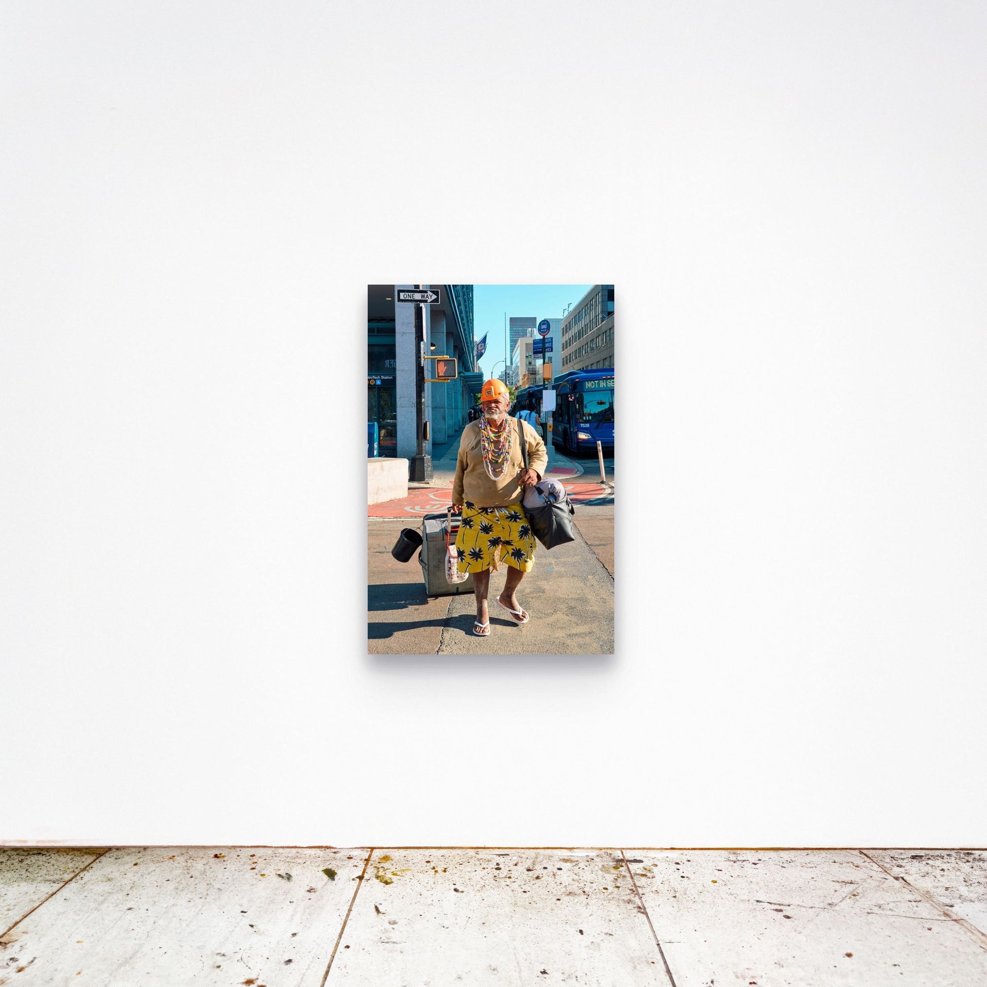Chloe Albert's fine art print 'Man Walking' shown unframed at 36 by 24 inches on a gallery wall, displaying the print at scale in a room setting.
