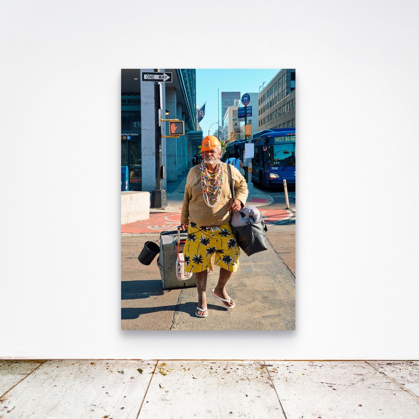 Chloe Albert's fine art print 'Man Walking' shown unframed at 60 by 40 inches on a gallery wall above a concrete floor, displaying the large statement size in a room.