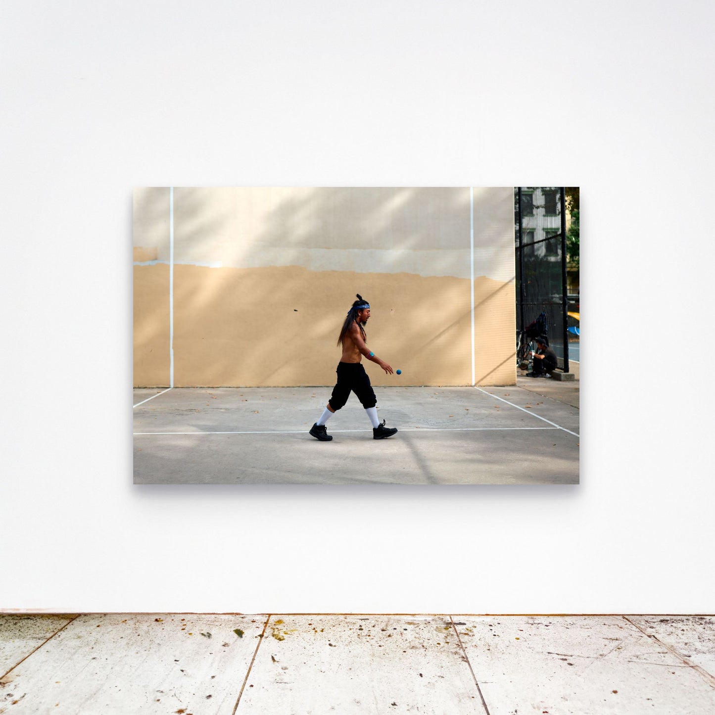 Chloe Albert's fine art print 'Metronome' shown unframed at 60 by 40 inches on a gallery wall above a concrete floor, displaying the large statement size in a room.