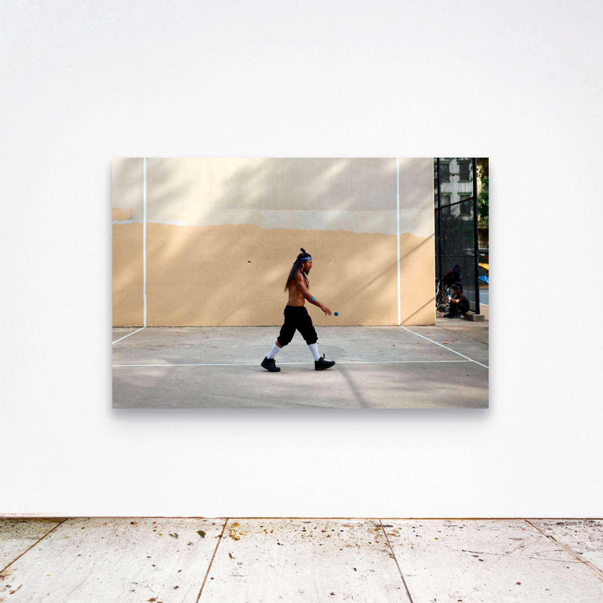 Chloe Albert's fine art print 'Metronome' shown unframed at 60 by 40 inches on a gallery wall above a concrete floor, displaying the large statement size in a room.