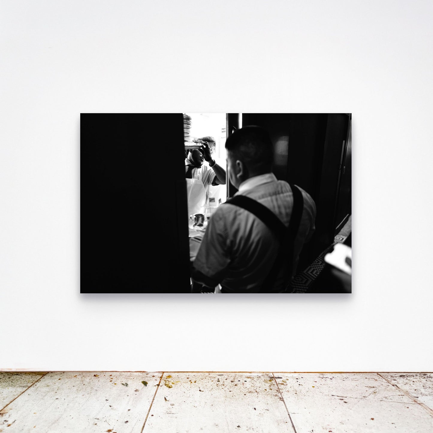 Chloe Albert's fine art print 'Sadelle's' shown unframed at 60 by 40 inches on a gallery wall above a concrete floor, displaying the large statement size in a room.