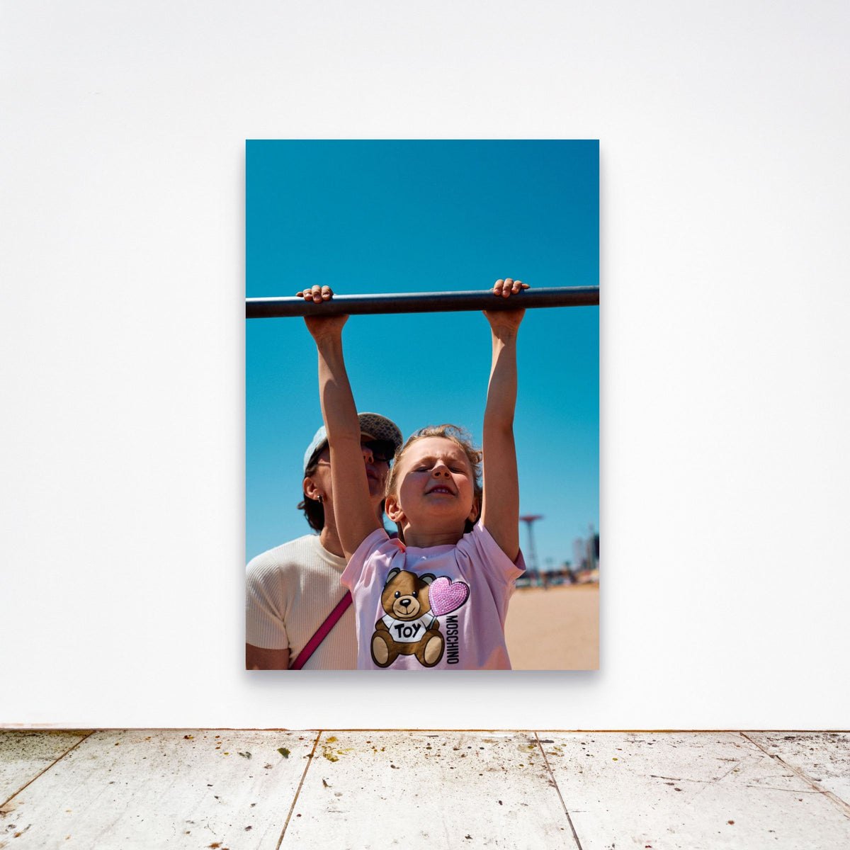 Chloe Albert's fine art print 'Suspended' shown unframed at 60 by 40 inches on a gallery wall above a concrete floor, displaying the large statement size in a room.