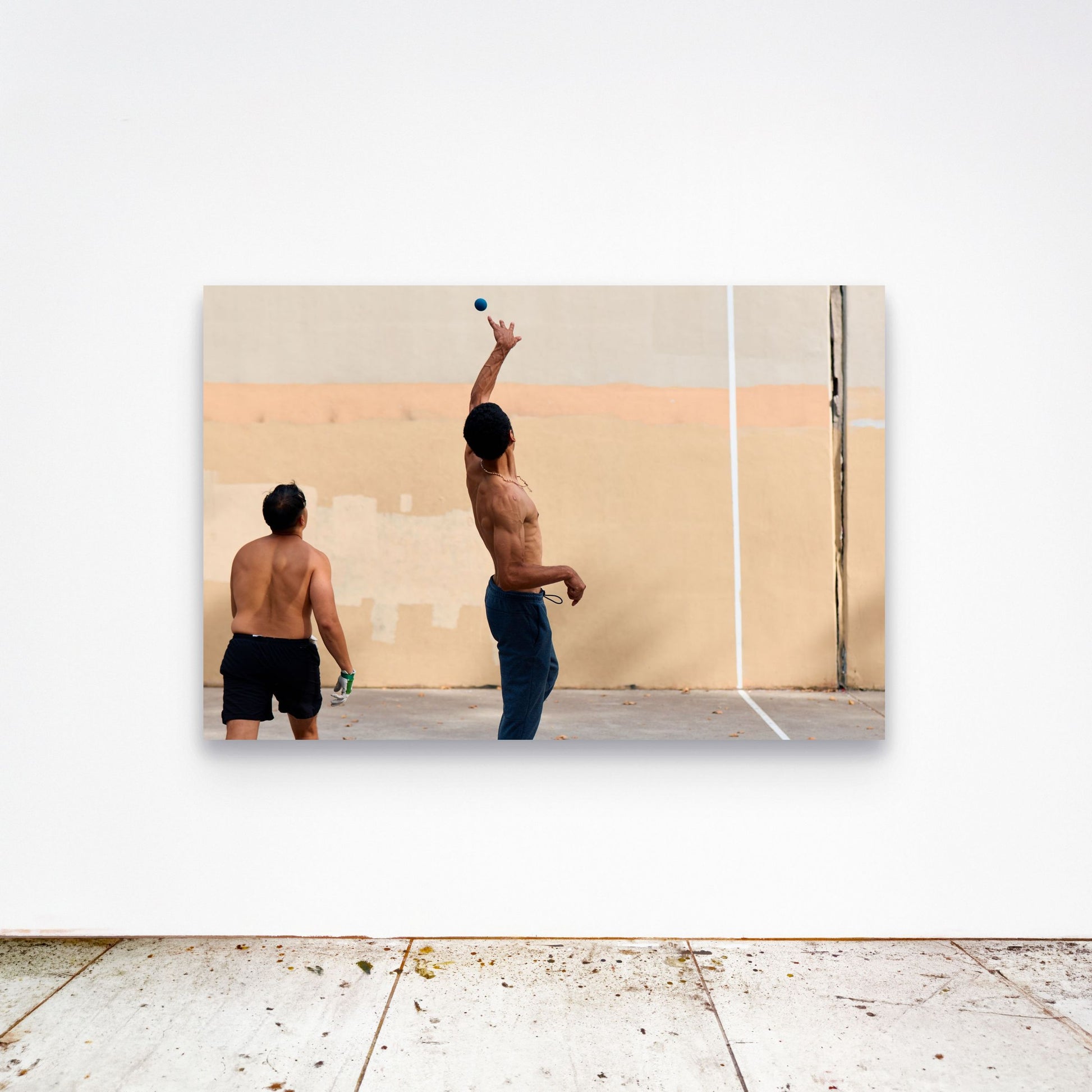 Chloe Albert's fine art print 'Suspension' shown unframed at 60 by 40 inches on a gallery wall above a concrete floor, displaying the large statement size in a room.