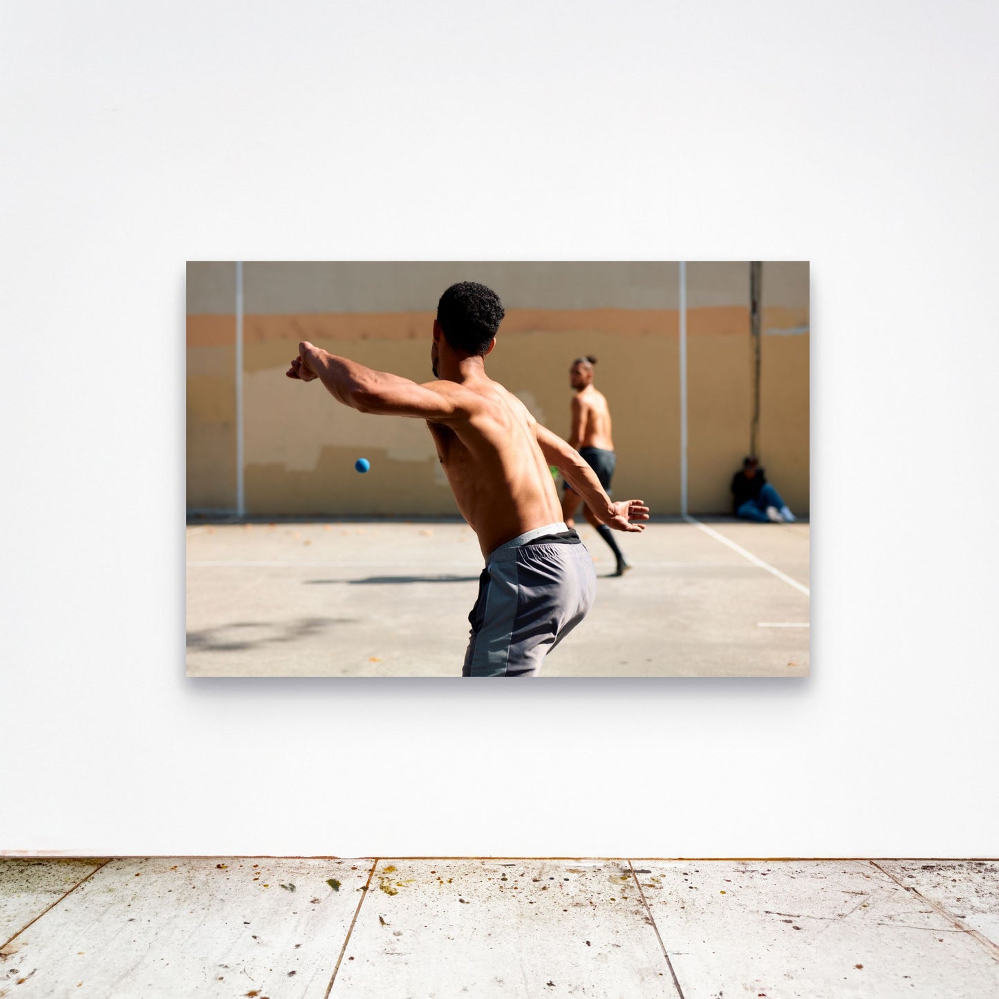 Chloe Albert's fine art print 'Torque' shown unframed at 60 by 40 inches on a gallery wall above a concrete floor, displaying the large statement size in a room.