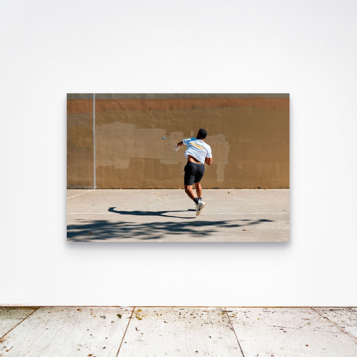 Chloe Albert's fine art print 'Velocity' shown unframed at 60 by 40 inches on a gallery wall above a concrete floor, displaying the large statement size in a room.