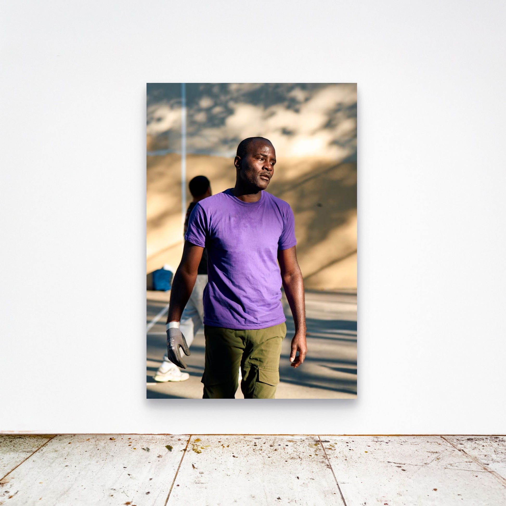 Chloe Albert's fine art print 'Vintage Olympian' shown unframed at 60 by 40 inches on a gallery wall above a concrete floor, displaying the large statement size in a room.