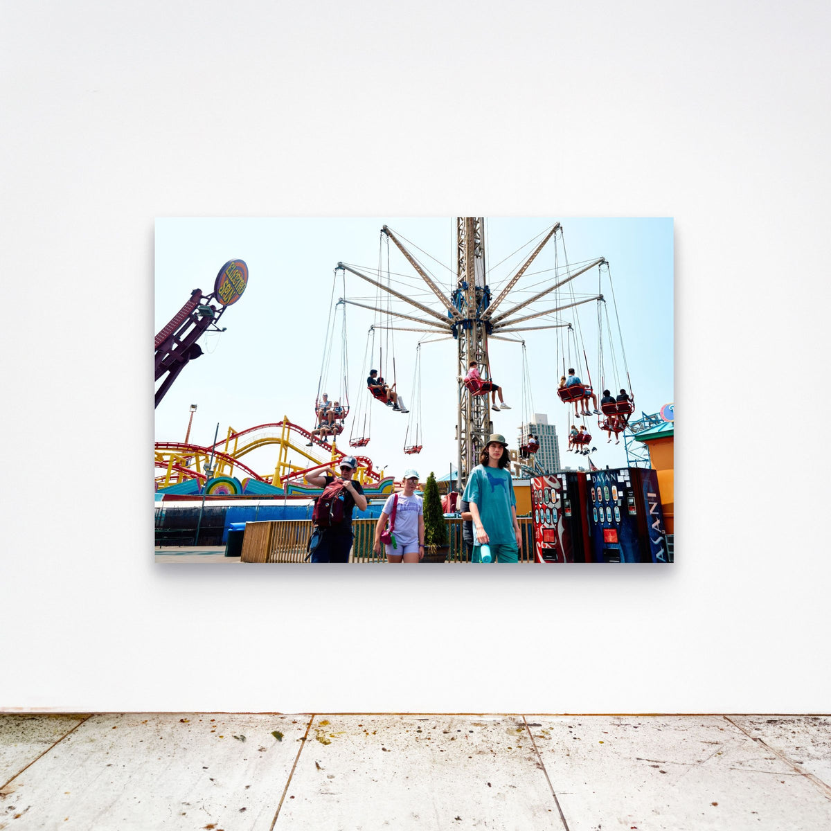Chloe Albert's fine art print 'Wave Swinger' shown unframed at 60 by 40 inches on a gallery wall above a concrete floor, displaying the large statement size in a room.