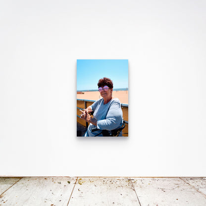 Chloe Albert's fine art print 'Woman On Broadwalk' shown unframed at 36 by 24 inches on a gallery wall, displaying the print at scale in a room setting.