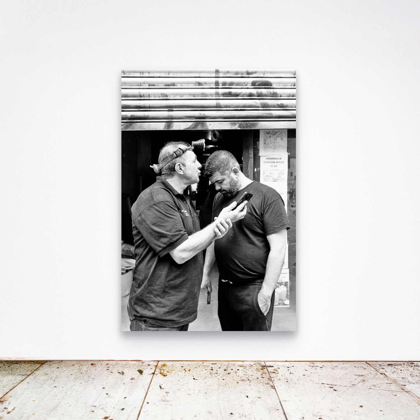 Chloe Albert's fine art print 'Workman' shown unframed at 60 by 40 inches on a gallery wall above a concrete floor, displaying the large statement size in a room.