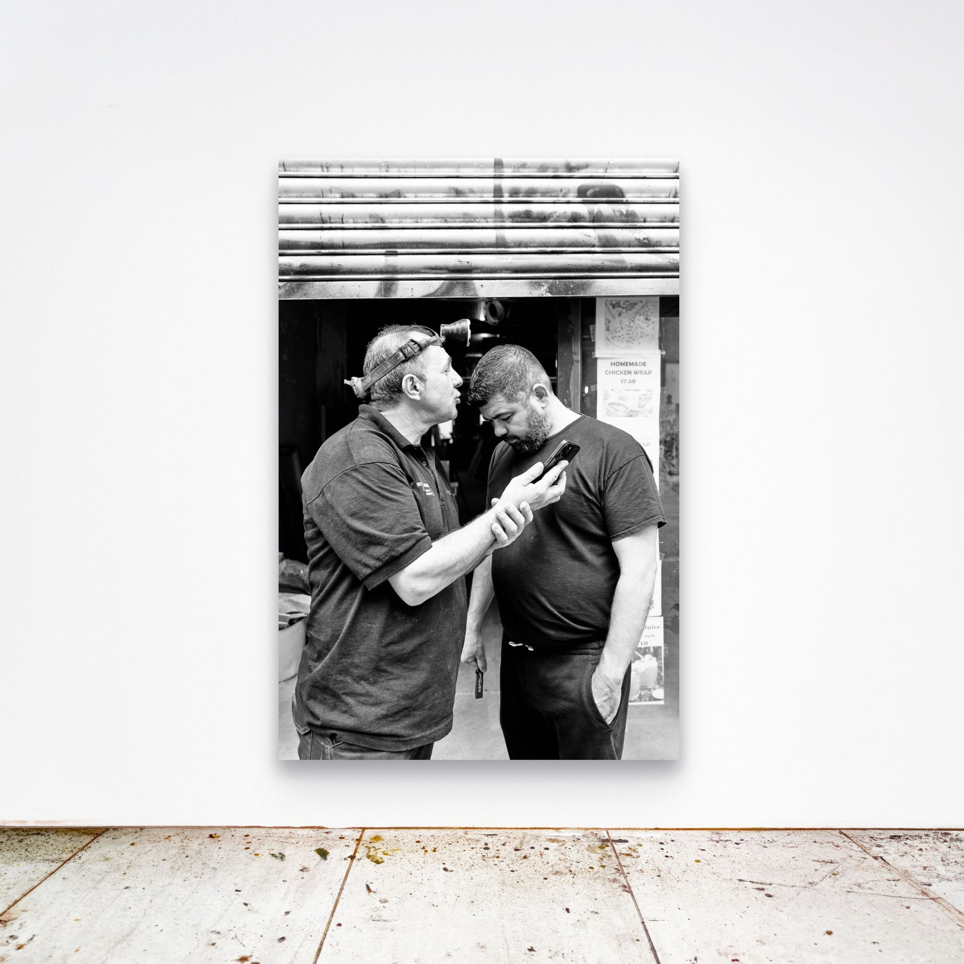 Chloe Albert's fine art print 'Workman' shown unframed at 60 by 40 inches on a gallery wall above a concrete floor, displaying the large statement size in a room.